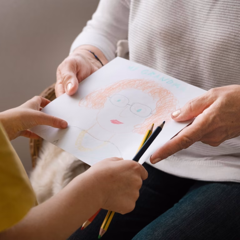 close-up-hands-holding-drawing